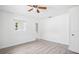 Bright bedroom with gray vinyl floors, ceiling fan, and closet for ample storage at 5758 20Th N Ave, St Petersburg, FL 33710