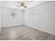 A bright bedroom with natural light, ceiling fan, neutral walls, and gray vinyl floors at 5758 20Th N Ave, St Petersburg, FL 33710