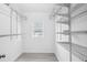 Walk-in closet boasts adjustable shelving system and bright natural light from the window at 5758 20Th N Ave, St Petersburg, FL 33710