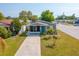 Charming single-story home with a well-maintained front yard, long driveway, and inviting blue front door at 5758 20Th N Ave, St Petersburg, FL 33710