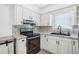 Modern kitchen featuring stainless steel appliances, white cabinetry, and patterned countertops and backsplash at 5758 20Th N Ave, St Petersburg, FL 33710