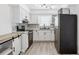 Updated kitchen featuring white cabinets, black appliances, stylish backsplash, and butcher block countertops at 5758 20Th N Ave, St Petersburg, FL 33710