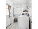 Bright laundry room with washer, dryer, tile floor, and convenient shelving at 5758 20Th N Ave, St Petersburg, FL 33710