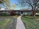 Charming single-story home with a tile roof and a brick pathway leading to the front door at 6305 Bahama Shores S Dr, St Petersburg, FL 33705