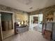 Spacious room with patterned wallpaper and sliding glass doors, awaiting renovation at 6305 Bahama Shores S Dr, St Petersburg, FL 33705