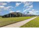 Beautiful house showcasing a well-manicured lawn, palm trees, and an inviting screened porch at 689 Chipper Dr, Sun City Center, FL 33573