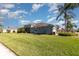 Well-maintained house featuring lush green lawn, palm trees, and beautiful landscaping at 689 Chipper Dr, Sun City Center, FL 33573