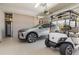 Spacious garage with epoxy flooring, car, and golf cart at 689 Chipper Dr, Sun City Center, FL 33573