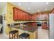 Spacious kitchen with barstool seating, stainless steel appliances and sleek granite countertops at 689 Chipper Dr, Sun City Center, FL 33573