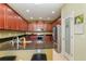 Kitchen featuring stainless steel appliances, granite countertops, a pantry and dark wood cabinets at 689 Chipper Dr, Sun City Center, FL 33573