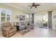 Cozy living room with a ceiling fan and lots of natural light at 689 Chipper Dr, Sun City Center, FL 33573
