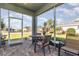 Inviting screened porch with outdoor seating and views of the well-manicured lawn at 689 Chipper Dr, Sun City Center, FL 33573