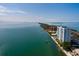 Scenic aerial view of the condominium building along the coast, showcasing water and nearby bridge at 7200 Sunshine Skyway S Ln # 3D, St Petersburg, FL 33711