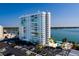 Aerial view of apartment complex with parking and waterfront views, surrounded by lush trees at 7200 Sunshine Skyway S Ln # 3D, St Petersburg, FL 33711