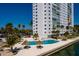 Aerial view of a condo building and pool area with palm trees and ocean views at 7200 Sunshine Skyway S Ln # 3D, St Petersburg, FL 33711