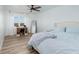 Bright bedroom features a comfortable bed, ceiling fan and hardwood floors at 7200 Sunshine Skyway S Ln # 3D, St Petersburg, FL 33711