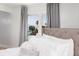 Bedroom featuring a tufted headboard, soft bedding, and a view of the water through the window at 7200 Sunshine Skyway S Ln # 3D, St Petersburg, FL 33711