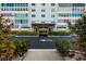 The Sky Harbour complex main entrance with manicured greenery, a covered entry, and ample parking at 7200 Sunshine Skyway S Ln # 3D, St Petersburg, FL 33711