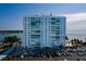 Waterfront condo building with a pool, tropical landscaping, and covered parking at 7200 Sunshine Skyway S Ln # 3D, St Petersburg, FL 33711
