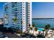 Exterior view of building with palm trees and pool area next to bay waters, perfect for relaxing at 7200 Sunshine Skyway S Ln # 3D, St Petersburg, FL 33711