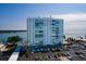 Exterior view of Sky Harbour condo building near the water featuring a large parking lot and well maintained landscaping at 7200 Sunshine Skyway S Ln # 3D, St Petersburg, FL 33711