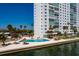 A waterfront building with a community swimming pool surrounded by tropical trees at 7200 Sunshine Skyway S Ln # 3D, St Petersburg, FL 33711