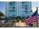 View of Sky Harbour condo's exterior showcasing a beautifully maintained lawn, parking area, and building entrance at 7200 Sunshine Skyway S Ln # 3D, St Petersburg, FL 33711