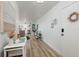 Charming entry with light wood floors, bright white walls and neutral accents at 7200 Sunshine Skyway S Ln # 3D, St Petersburg, FL 33711
