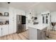 Bright kitchen featuring white cabinets, a gray island, stainless steel appliances, and wood-look flooring at 7200 Sunshine Skyway S Ln # 3D, St Petersburg, FL 33711