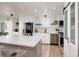 Contemporary kitchen featuring white cabinetry, stainless steel appliances, and a spacious island with seating at 7200 Sunshine Skyway S Ln # 3D, St Petersburg, FL 33711