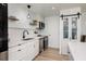 Modern kitchen featuring white cabinets, quartz countertops, stainless steel appliances, and sliding barn door at 7200 Sunshine Skyway S Ln # 3D, St Petersburg, FL 33711