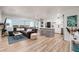 Open-concept living space featuring a large sofa, an island with seating, and natural light from expansive windows at 7200 Sunshine Skyway S Ln # 3D, St Petersburg, FL 33711