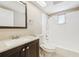 Bathroom featuring shower-tub combo, white tiles, dark vanity and a large mirror at 7315 Lincoln Park Ln, Port Richey, FL 34668