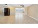 Living room with modern tiled floor, neutral walls and big opening into adjoining room at 7315 Lincoln Park Ln, Port Richey, FL 34668