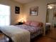 Cozy bedroom with a comfortable bed, mirrored closet, and soft natural light from the window at 7392 Meadow Brook Ln, Spring Hill, FL 34606