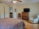 Bright bedroom featuring hardwood floors, comfortable seating and a large television at 7392 Meadow Brook Ln, Spring Hill, FL 34606