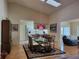 Bright dining room featuring a glass table, wood floors, and an open layout with skylight at 7392 Meadow Brook Ln, Spring Hill, FL 34606