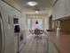 Bright, galley-style kitchen with white cabinets and appliances, plus an adjacent dining area at 7392 Meadow Brook Ln, Spring Hill, FL 34606