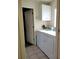 Functional laundry room with a washer, dryer, and storage cabinet for convenience at 7392 Meadow Brook Ln, Spring Hill, FL 34606