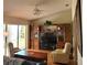 Cozy living room featuring a ceiling fan, entertainment center, and comfortable seating at 7392 Meadow Brook Ln, Spring Hill, FL 34606
