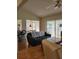Comfortable living room featuring a leather sofa, ceiling fan, and views into the dining area and screened-in patio at 7392 Meadow Brook Ln, Spring Hill, FL 34606