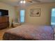 Comfortable primary bedroom featuring wood floors and a recliner, providing a cozy retreat at 7392 Meadow Brook Ln, Spring Hill, FL 34606