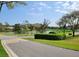 Scenic street view overlooking a pond, golf course, and lush landscaping in a well-maintained community at 7392 Meadow Brook Ln, Spring Hill, FL 34606