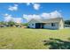 Spacious backyard showcasing a well-maintained lawn, mature landscaping and ample space for outdoor enjoyment at 7509 Mesa St, North Port, FL 34287