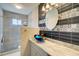 This bathroom features an updated vanity, vessel sink, glass shower, and designer tile at 7509 Mesa St, North Port, FL 34287
