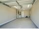 Clean garage features overhead lighting, door, and ample space at 7509 Mesa St, North Port, FL 34287