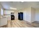 Bright kitchen with white cabinets, laminate countertops, black appliances, and stylish light wood-look flooring at 7509 Mesa St, North Port, FL 34287