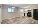 Bright and airy kitchen area with white cabinets, black appliances, modern flooring, and natural light from multiple windows at 7509 Mesa St, North Port, FL 34287