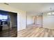 Kitchen and dining area showcasing wood-look floors, black appliances, white cabinets, and abundant natural light at 7509 Mesa St, North Port, FL 34287