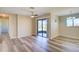 Bright living space boasts stylish flooring, a ceiling fan, and sliding glass door to the outdoors at 7509 Mesa St, North Port, FL 34287